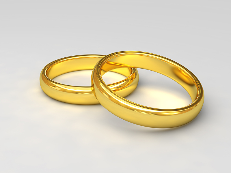 Dieses Bild zeigt zwei goldene Ringe welche sich leicht überlappen.